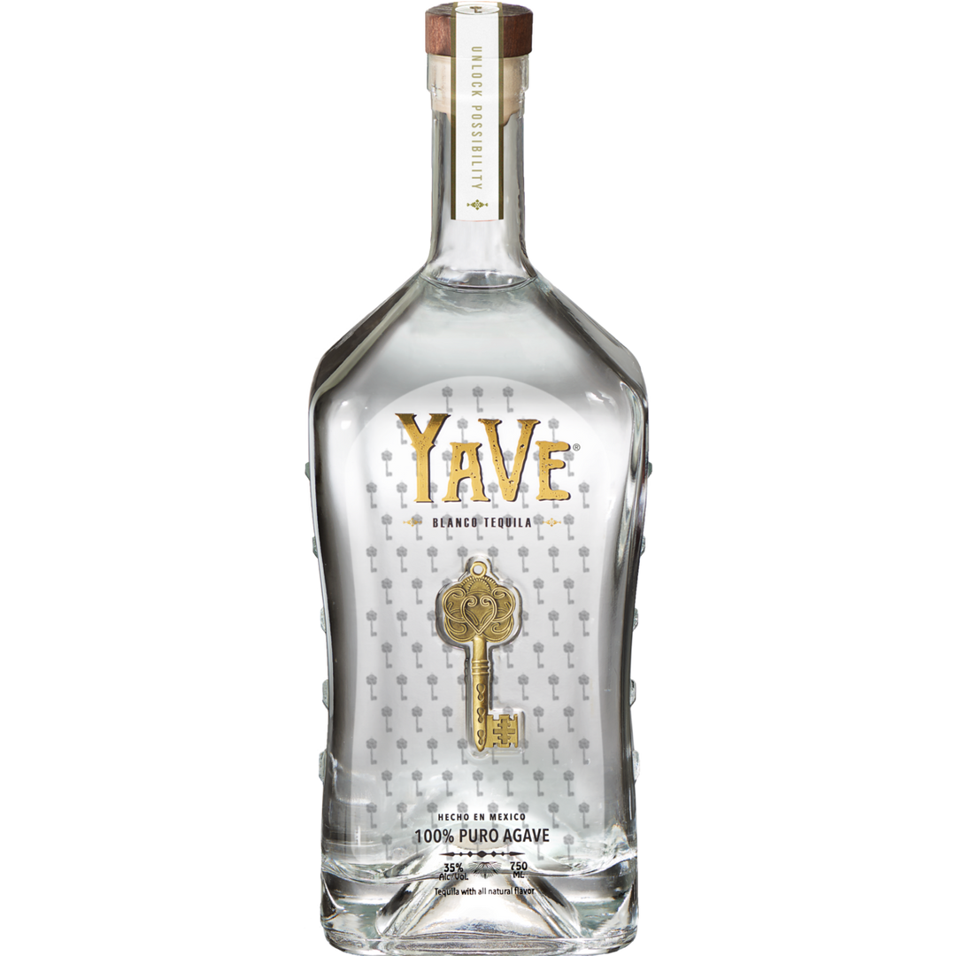 A clear glass bottle of YaVe Tequila Blanco, featuring bold gold "YaVe Tequila" branding and a gold key design. This handcrafted, ultra-smooth tequila with a wooden cap is crystal clear—ideal for your next margarita.