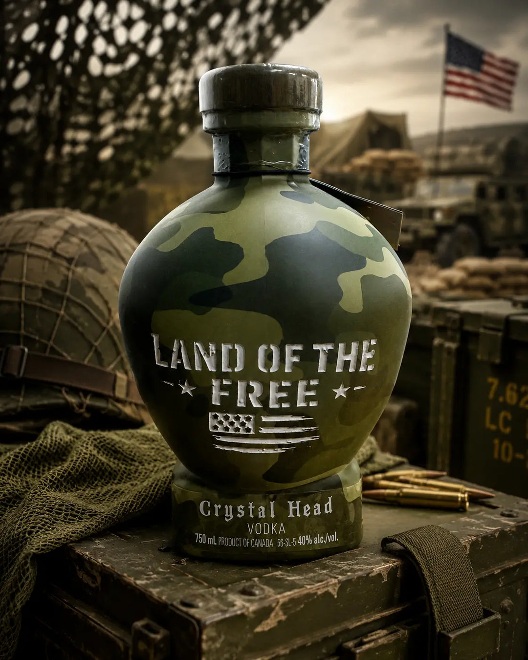 The Crystal Head Camo “Land Of The Free” Deep Etch Custom Bottle by Crystal Head Vodka is displayed on military gear with bullets and an American flag, featuring patriotic etched artwork for a bold, collectible look.