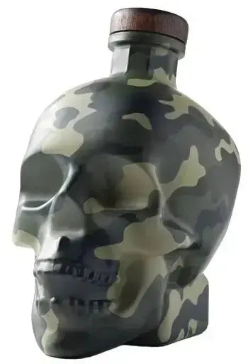 The Crystal Head Vodka Camo “Land Of The Free” Deep Etch Custom Bottle features a human skull shape with a bold camouflage design and a wooden cap.