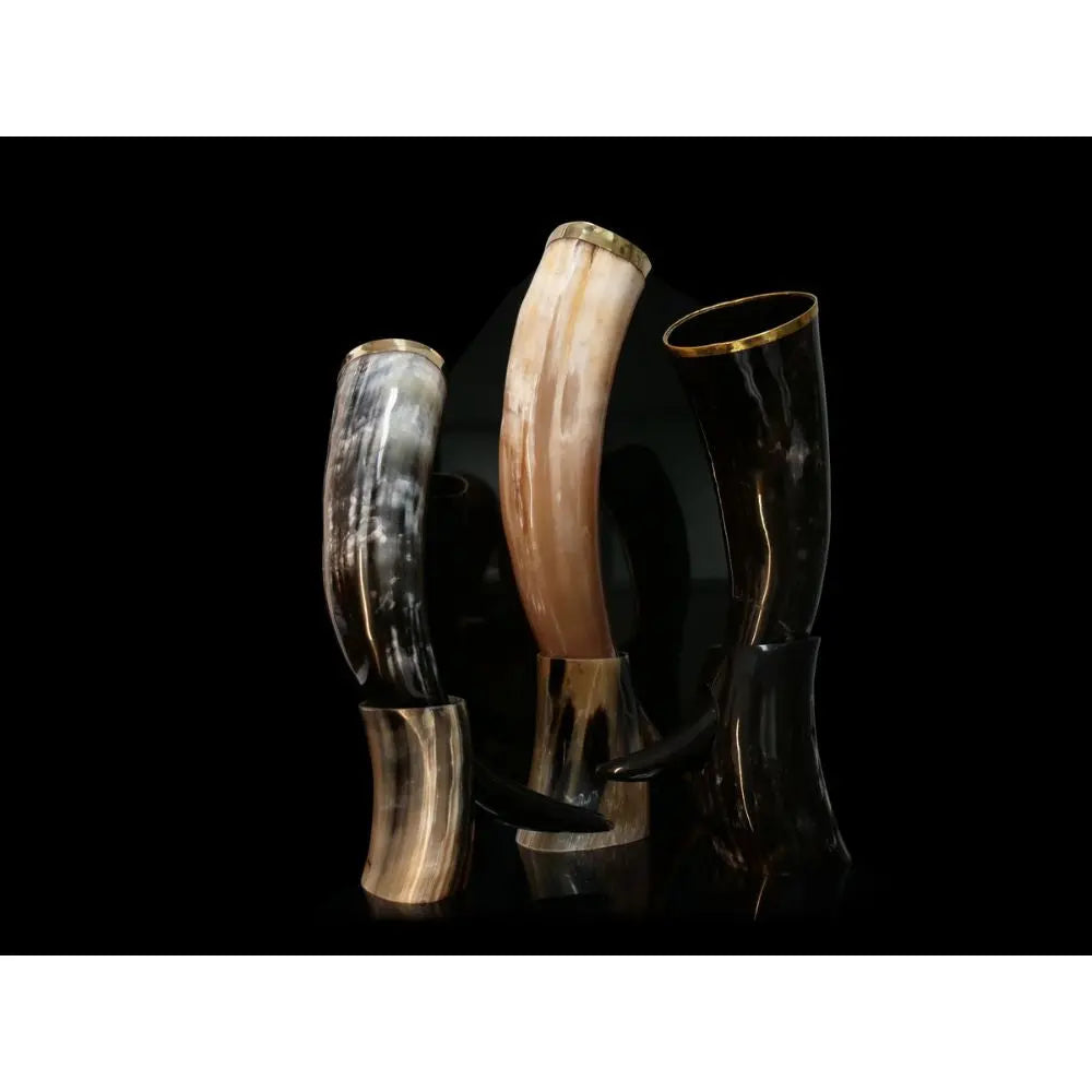 The Eldenwood Straight Bourbon Whiskey 3 Pack features three polished drinking horns in black, tan, and cream on matching stands—perfect for enjoying your favorite bourbon. From Eldenwood.