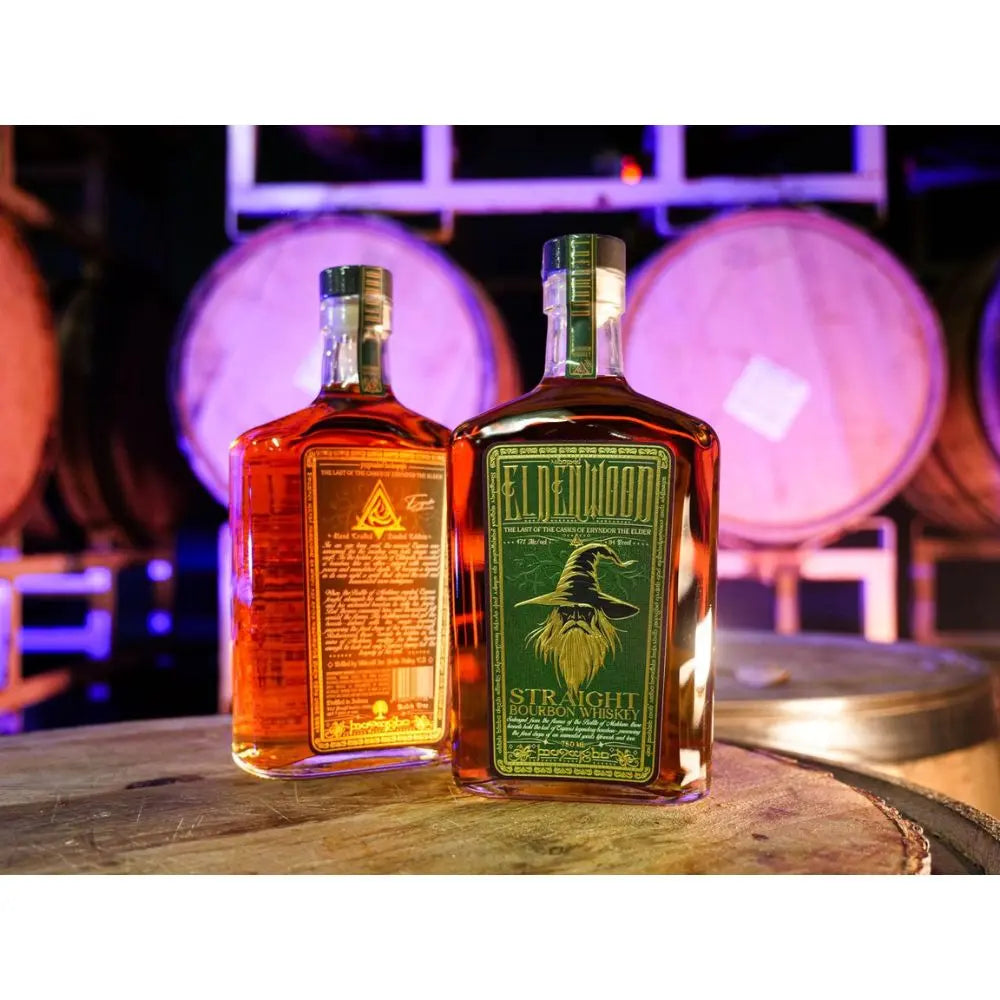 Two bottles of Eldenwood Straight Bourbon Whiskey sit atop a wooden barrel, with large oak barrels blurred in the background and purple lighting casting a glow over the scene.