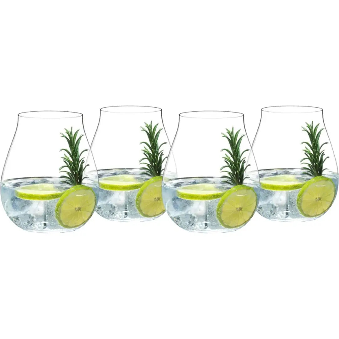 Four Riedel Gin glasses from the Riedel Gin Set of 4 are filled with ice, water, lime slices, and sprigs of rosemary, arranged in a row to evoke the elegance of this classic cocktail set.