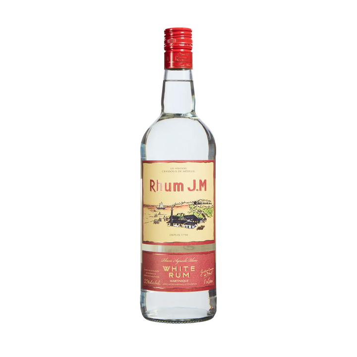 A clear glass bottle of Rhum J.M. Agricole Blanc 110 Proof White Rum features a red cap and cream and red label with a distillery illustration and gold text, photographed on a plain white background.