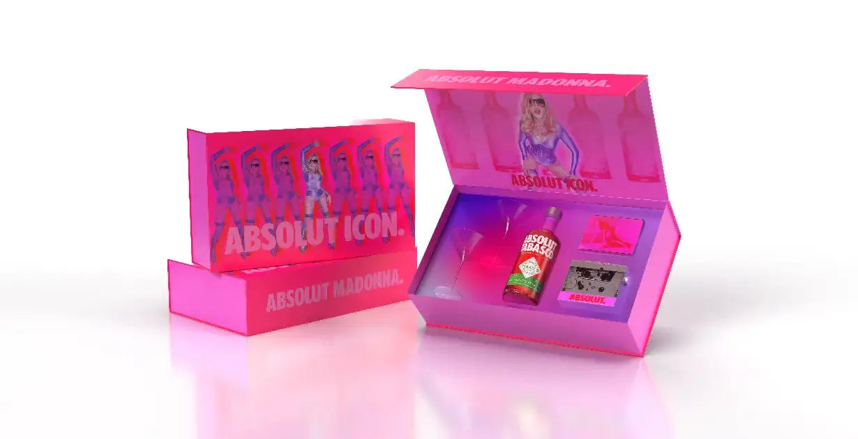 The Madonna x Absolut Icons Cocktail Kit by Absolut Vodka is a limited edition gift set with pink packaging featuring Madonna’s image, a vodka bottle, glass, cassette tape, collectibles, and a box labeled “Absolut Madonna” and “Absolut Icon.”.