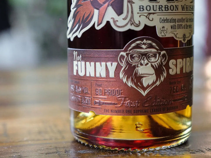 A close-up of the Rocket Man Bourbon Whiskey bottle label shows a chimpanzee in glasses and bold "Rocket Man" branding, with decorative details and political parody elements typical of this limited release.