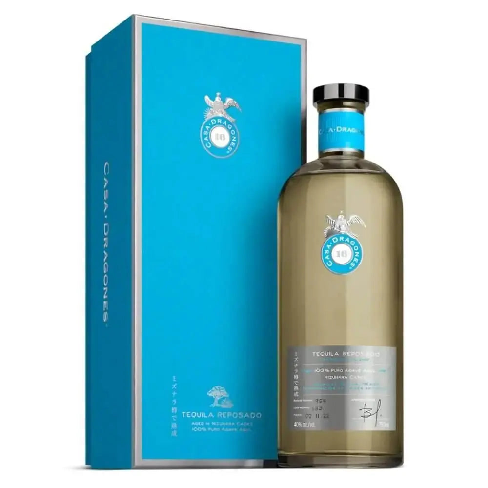 A bottle of Tequila Casa Dragones Reposado Mizunara Oak “World’s Best Dad” Deep Etched Tequila is displayed with its matching box—both featuring stylish silver and white accents, making it a sophisticated Father’s Day gift.