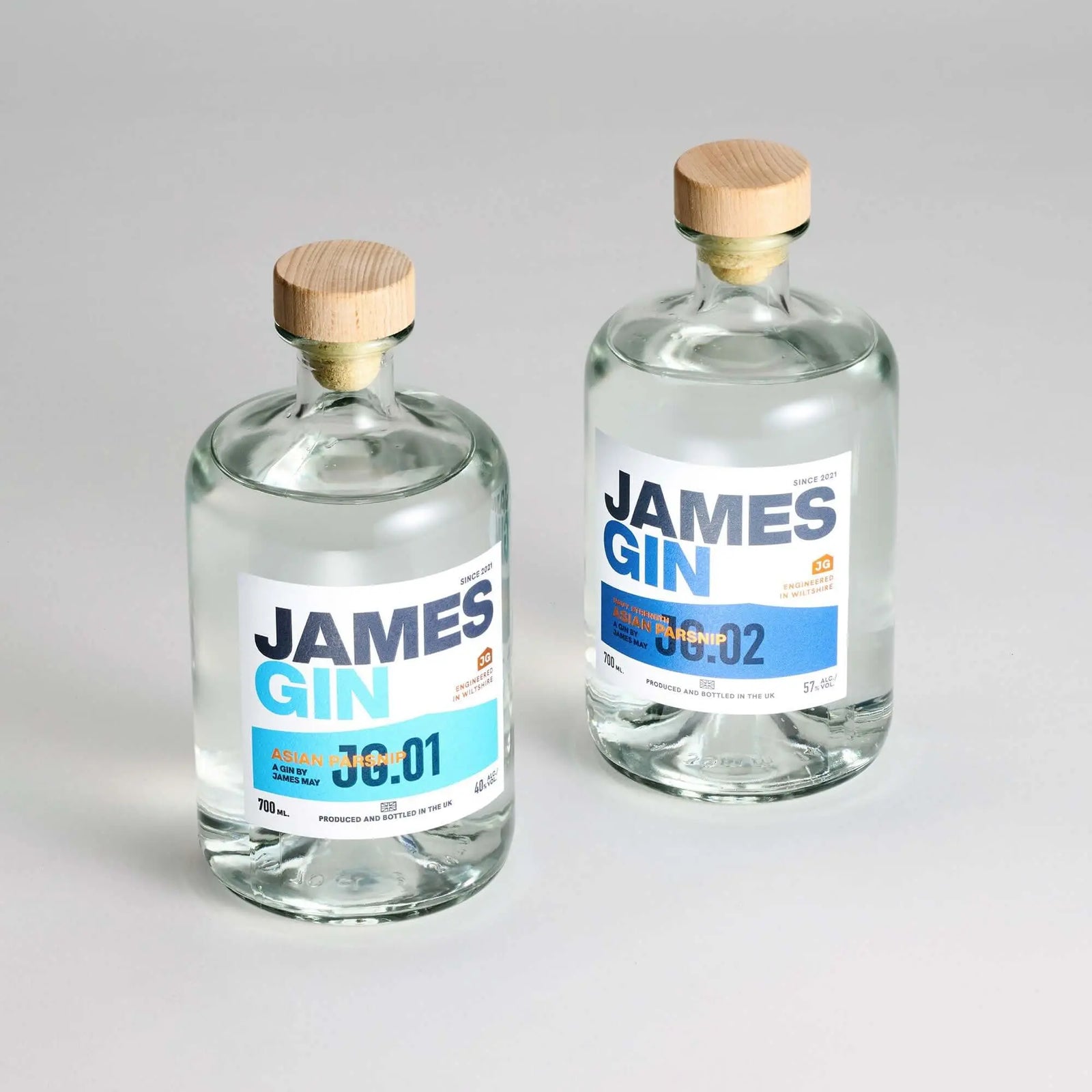 Two clear James Gin US bottles from The Tupac 2 Bottle Set, both with modern blue and white labels and wooden caps, are shown on a white background. Includes souvenir gift key chain.