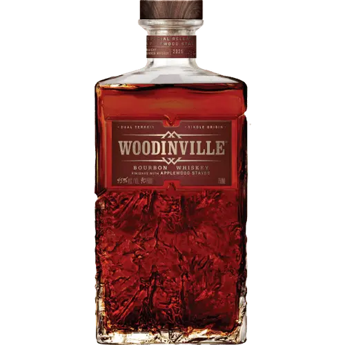 A bottle of Woodinville Straight Bourbon Finished With Toasted Applewood Staves features a textured glass design and a brown label displaying the Woodinville brand name and details. Crafted in the Pacific Northwest, this bourbon is finished with toasted applewood staves for a distinctive character.